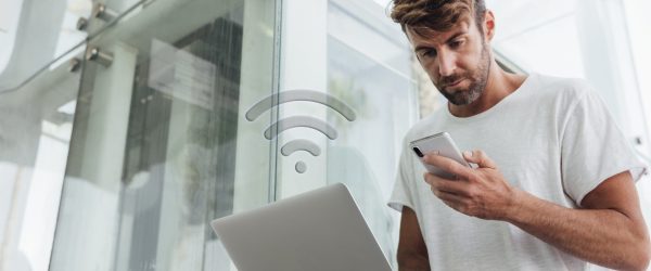 bearded-man-checking-portable-devices-min