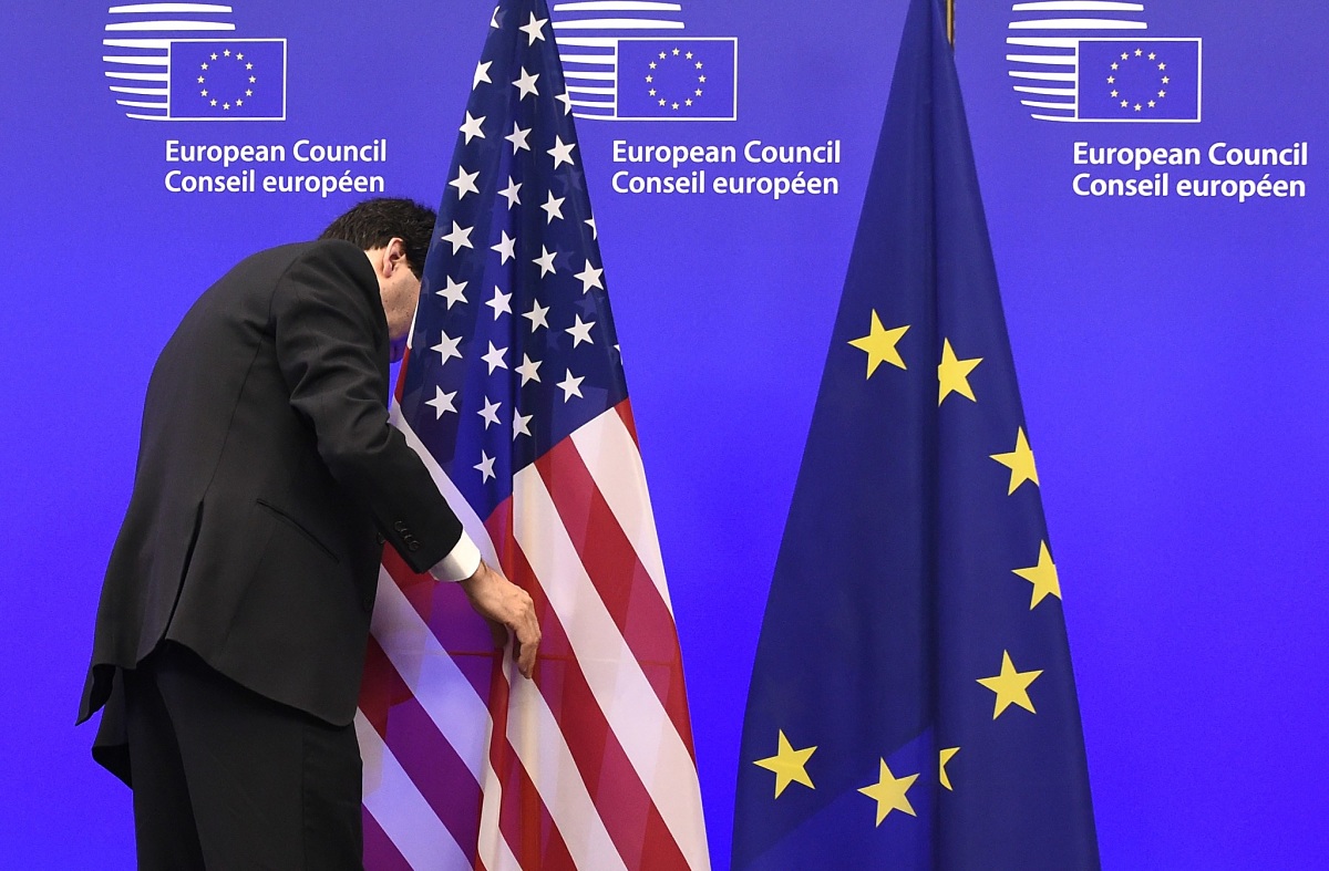 A member of the European Council adjusts the US flag before the meeting with European Union President Donald Tusk and the Vice-President of the United States Joe Biden, on February 6, 2015 at the EU Headquarters in Brussels. AFP PHOTO/JOHN THYS        (Photo credit should read JOHN THYS/AFP via Getty Images)