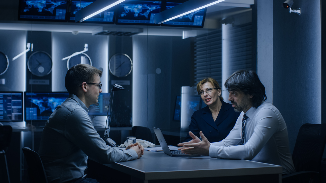 On a Job Interview Two Senior Managers Ask Young Candidate Questions. Secret Service Recruiting Talented Young Man. Serious People Working in Government Agency.