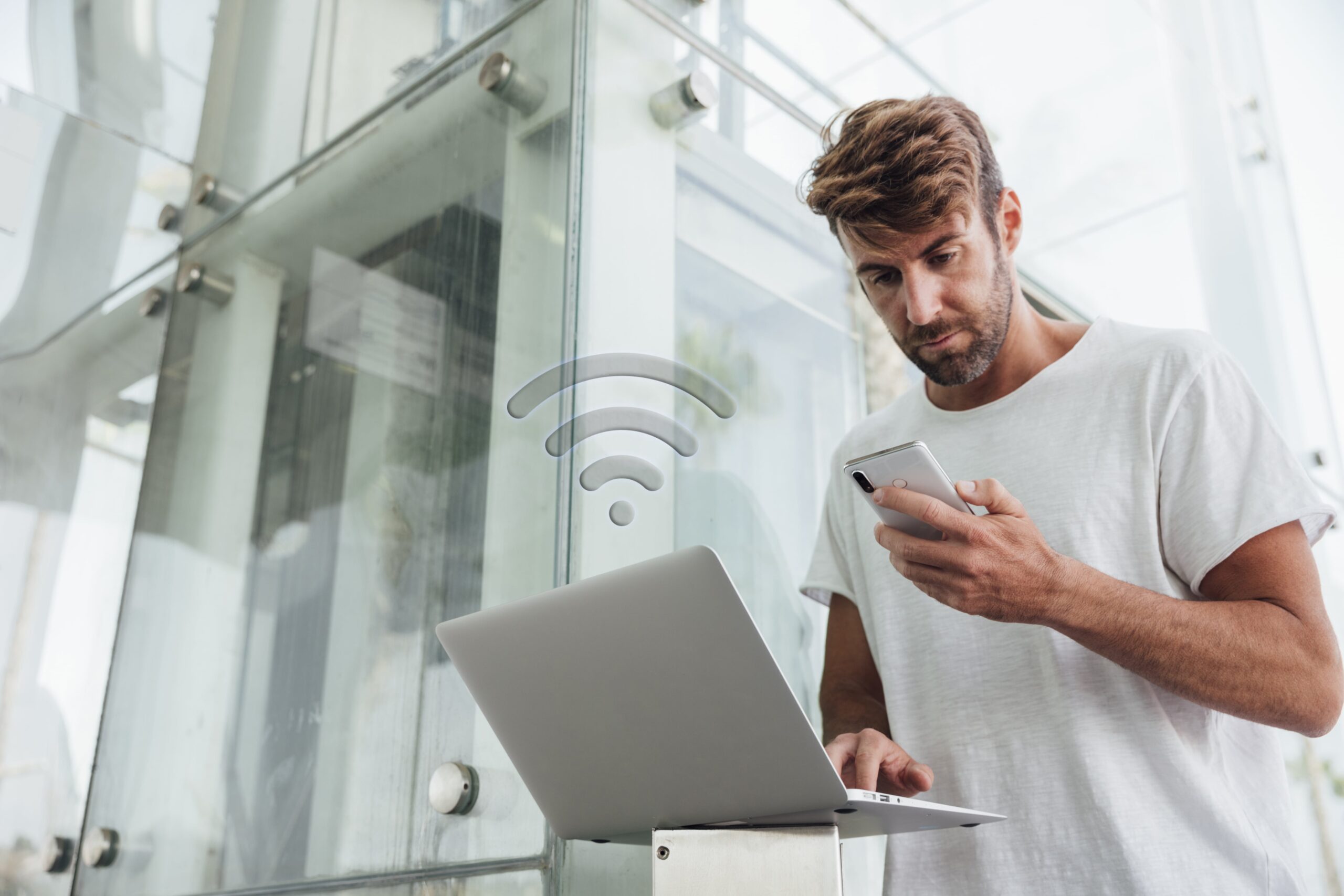 bearded-man-checking-portable-devices-min