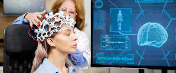 doctor-arranging-scanning-device-head-female-patient-min